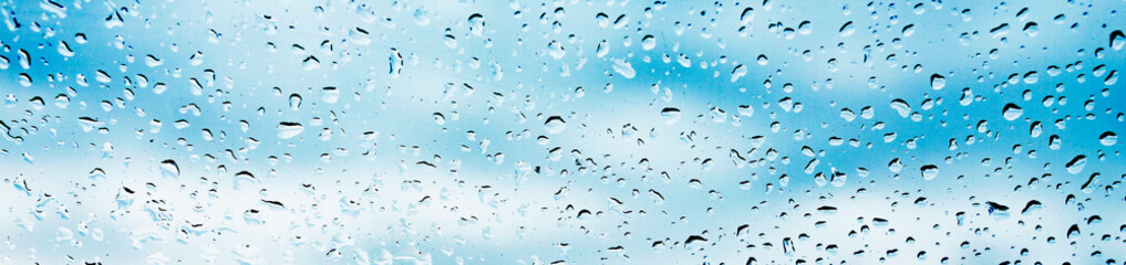 Background raindrops on the window. Beautiful blue background