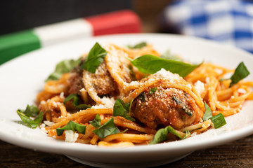 Beef meatballs with bolognese sauce and spaghetti.