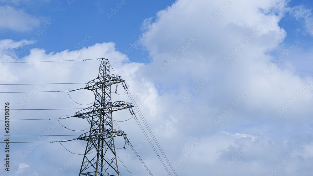 Wall mural power transmission tower on background of blue sky