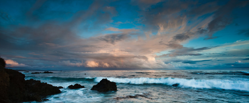 sunset over rocky coastline of california