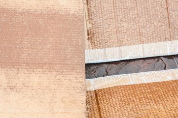 The texture of cardboard, torn into three parts