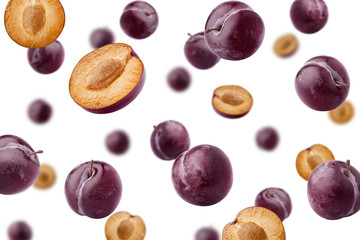 Falling plum isolated on white background, selective focus