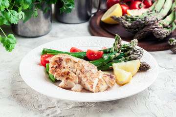 Fried cod fillet with green asparagus