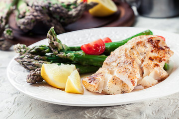 Fried cod fillet with green asparagus