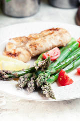 Fried cod fillet with green asparagus