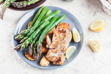 Fried cod fillet with green asparagus
