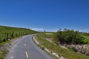Jordan River Parkway Trail, Redwood Trailhead bordering the Legacy Parkway Trail, panorama views with surrounding trees and silt filled muddy water along the Rocky Mountains, Salt Lake City, Utah. 