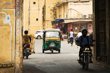 City life with Auto rickshaw (also known as Tuc Tuc) and motorbikes through the streets of Jaipur. Jaipur is the capital of the Indian state of Rajasthan, India.