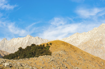 Stunning view of some peaks of  the Himalayas Mountains in Triund. Sunny beautiful day with some clouds. Dharamshala, Himachal Pradesh, India