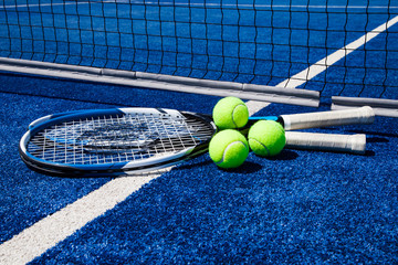 Tennis ball with racket on court