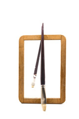 old wooden frame with used brush, on white background