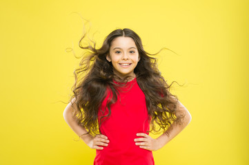 Wind can also damage hair. Strong persistent winds can create tangles and snags in wavy and curly long hair. Things you doing to damage your hair. Girl adorable kid long wavy hair yellow background