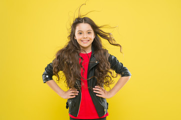 Her hair radiates health. Wind can also damage hair. Strong persistent winds can create tangles and snags in wavy long hair. Protect hair from wind damage. Girl adorable kid long wavy hairstyle