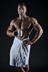 Morning coffee. Sexy sportsman wipe body towel after shower. Man muscular fit bare torso. Athlete...