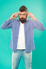 Hipster with beard listening music. Handsome music lover. Man in headphones. Streaming music sites...
