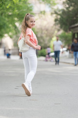 Obraz premium Looking her very best in this stylish and comfortable wear. Adorable stylish girl. Small fashion model with stylish look. Little cute child with long blond hair in stylish fashion wear