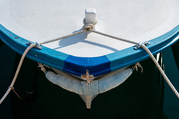 Bow of a small fishing boat with ropes