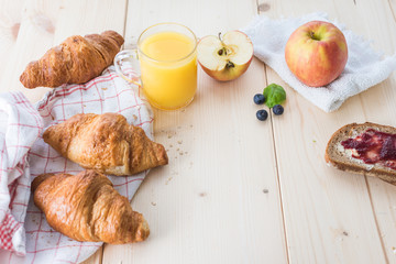 Breakfast on a wooden simple table.. Croissants Breakfast with aromatic tast. Good morning, great start to the day.