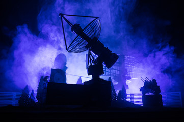 Silhouettes of satellite dishes or radio antennas against night sky. Space observatory.