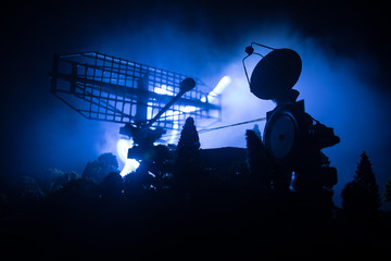 Silhouettes of satellite dishes or radio antennas against night sky. Space observatory.