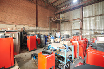 Background inmage of industrial warehouse crammed with metal and spare parts, copy space