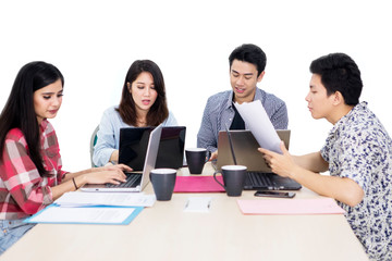 Fototapeta premium Busy employee team work with laptops on studio