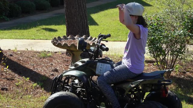 Little girl on a 4 wheeler.