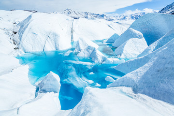 Fototapeta na wymiar Deep blue pool of flooded ice cave on the Matanuska Glacier in Alaska's Chugach Range.