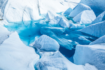 Lake on top of the Matanuska Glacier in Alaska. The deep blue water has flooded an old ice cave or...