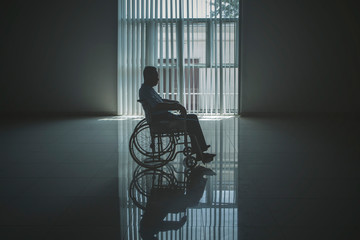 Fototapeta Lonely elderly man looks sad in the wheelchair obraz