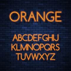 Obraz premium Glowing neon alphabet on brick wall background