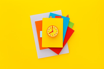 Stack of notebooks on colorful background. Top view.