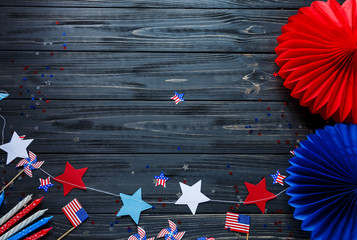 Decorations for 4th of July day of American independence, flag, candles, straws. USA holiday decorations on a wooden background, top view, flat lay - obrazy, fototapety, plakaty