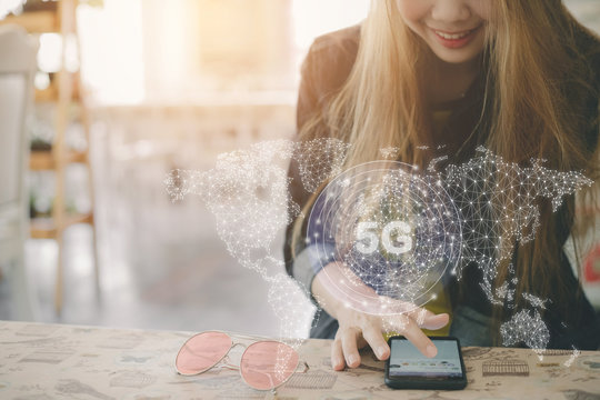 Young women playing social media with icons 5 g,Element of this image furnished by Nasa