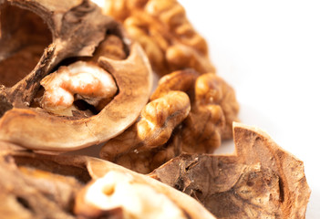 Peeled walnuts with broken shell isolated on white background. Macro. Walnuts close-up.