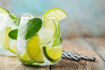 Two Mojito cocktail with ice cubes in a glass.
