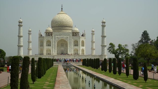 A hand held, long shot of the four white towers of the beautiful marble mosque.