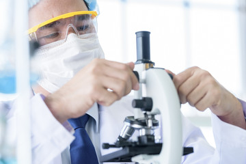 Fototapeta premium Asian young man student scientist researching and learning in a laboratory.