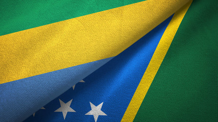 Gabon and Solomon Islands two flags textile cloth, fabric texture