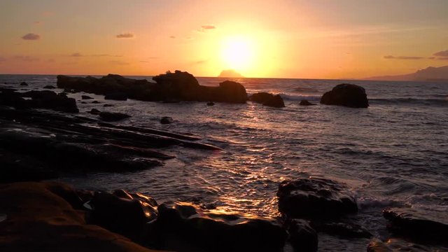 The sun rising above the ocean