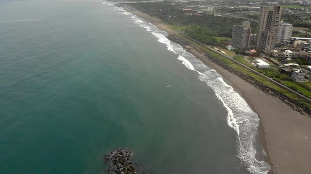 AERIAL: Above Ocean Waves on Coastline Pan Up
