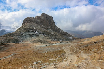 landscape with peaks covered by snow and clouds