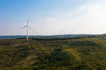 The windmills on the top of a mountain. They generate green energy from the nature.