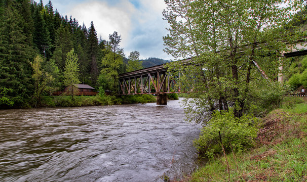 Bridge over flowing river with house near Avery Idaho