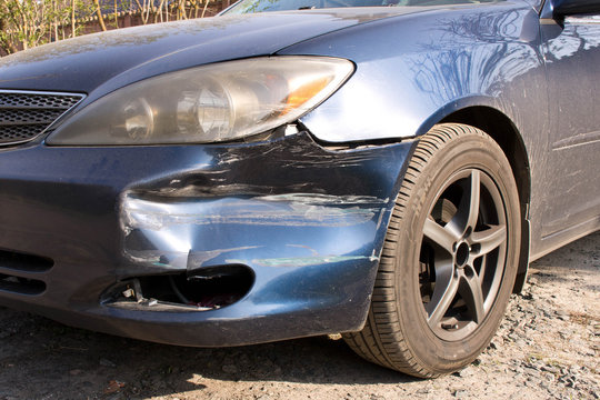 Damaged car.  Broken front bumper. The concept of road safety. Close up.