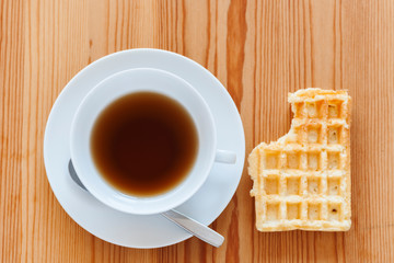 Teacup with biscuit in top view