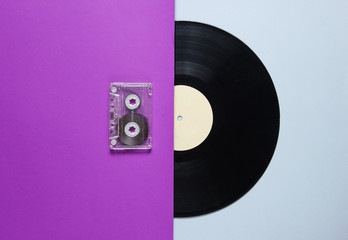 Audio cassette, vinyl record on a purple gray background. Retro style. Top view