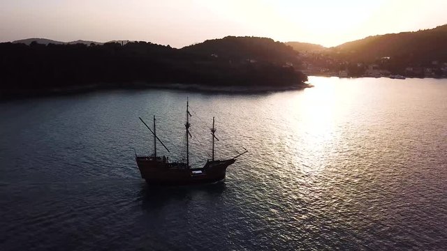 Pirate ship sailing near Dubrovnik, Croatia during golden hour - (Aerial Shot)