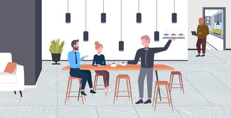 waiter serving drinks to businesspeople couple man woman having break business time coffee point concept flat full length modern cafe interior horizontal