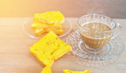 Coffee and toast on the wooden table